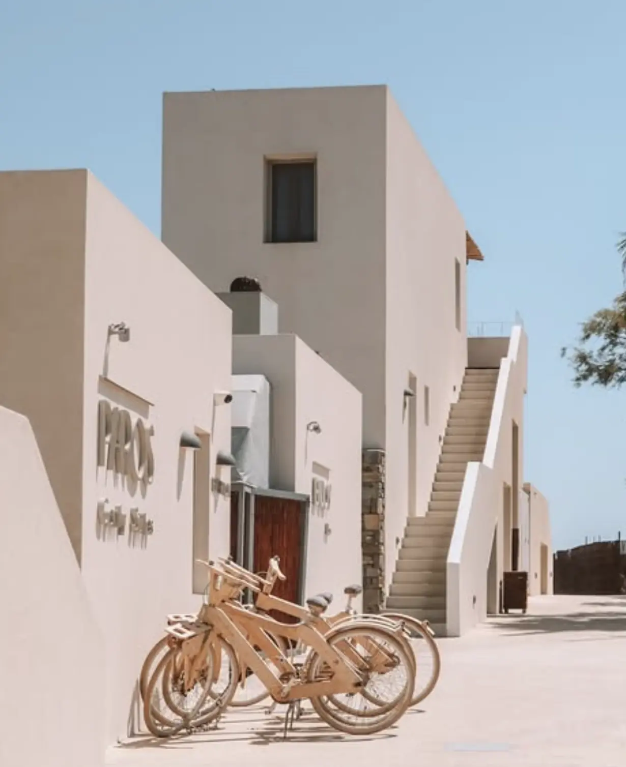 Bicycles for guests outside the whitewashed buildings of Paros Comfy Suites